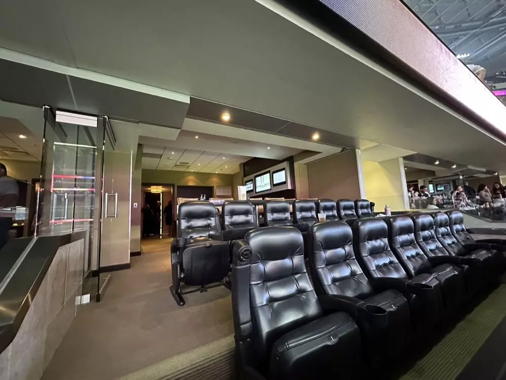 Leather, stadium-style seats within an Owners Club suite.